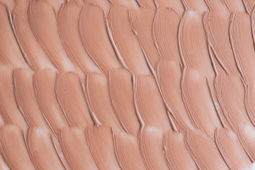 Obraz premium Beige smear of foundation texture. Cosmetics concept isolated on white background.