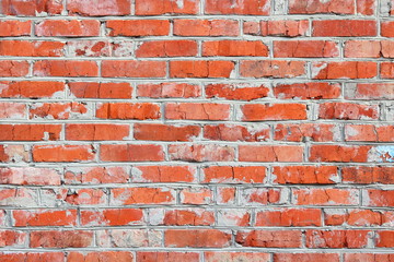 Fototapeta premium wall of bright old red brick as beautiful loft-style background for modern interior design and exterior of industrial premises, apartments and houses