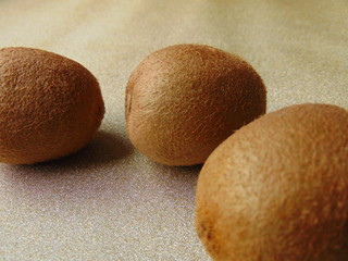 Juicy kiwis group of fruit isolated on golden background.
