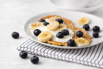 Healthy pancakes with fresh berry, fruits and yogurt. Summer breakfast concept.