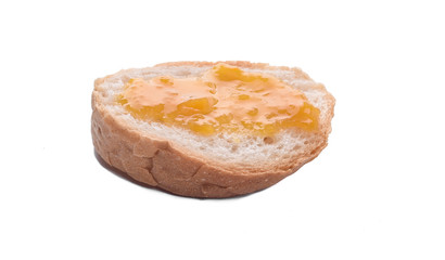 Sliced of sourdough Loaf with mango jam on top isolated on white background