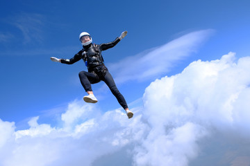 Fototapeta na wymiar Girl in leather jacket is flying in the amazing sky.