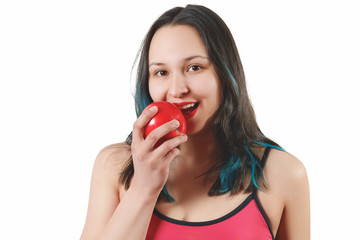 portrait of a smiling girl in tight clothes for fitness. holding a large red Apple in front of him. isolated on white background