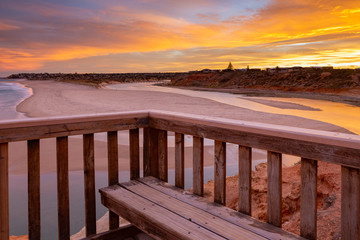 Fototapeta na wymiar A beautiful sunrise at southport port noarlunga south australia overlooking the wooden staircase ocean and cliffs on the 30th April 2019