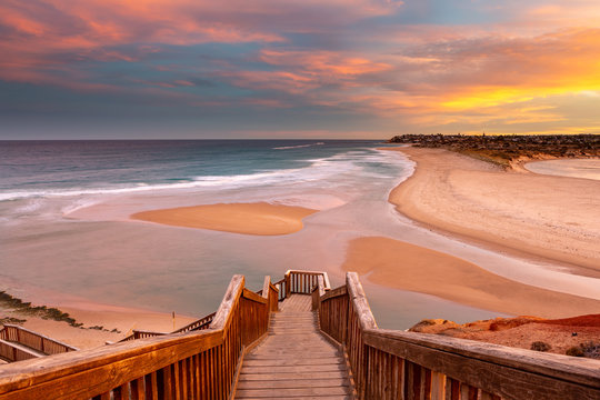 A beautiful sunrise at southport port noarlunga south australia overlooking the wooden staircase ocean and cliffs on the 30th April 2019