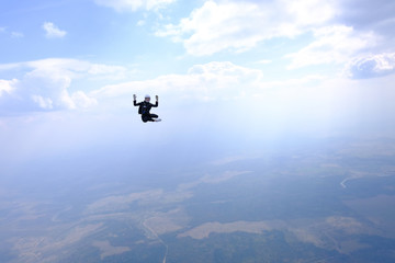 Fototapeta na wymiar Girl in leather jacket is flying in the amazing sky.