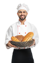 Chef with fresh bread on white background