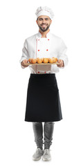 Chef with fresh buns on white background