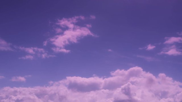 White clouds are moving around across the sky.  Purple tone, time lapse