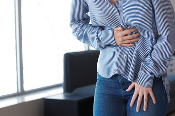 Woman suffering from stomachache at home
