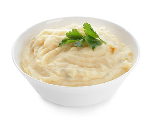 Bowl with tasty mashed potato on white background