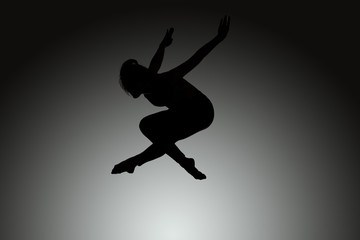 Fototapeta na wymiar athletic jumping girl studio shot