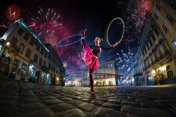 Night street circus performance whit clown, juggler. Festival city background. fireworks and...