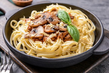 Frying pan with tasty boiled pasta on table