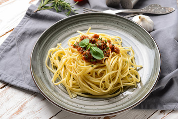 Plate with tasty boiled pasta on wooden table