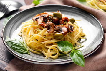 Plate with tasty boiled pasta on table
