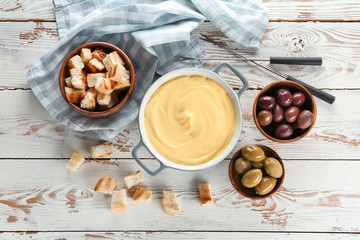 Cheese fondue with snacks on table