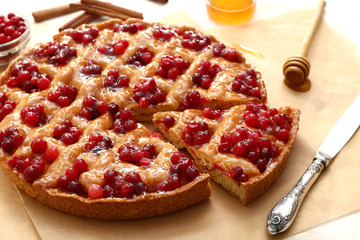 Tasty cranberry pie on table