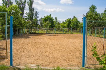 Fototapeta na wymiar Volleyball court with yellow sands in a beautiful sunny day.