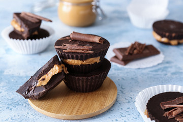 Tasty chocolate peanut butter cups on table