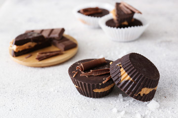 Tasty chocolate peanut butter cups on table