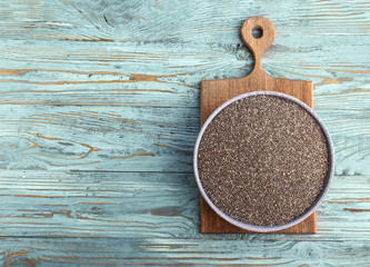 Bowl with chia seeds on wooden table