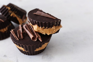 Tasty chocolate peanut butter cups on light background