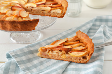 Piece of tasty apple pie on table