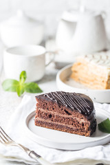 Delicious chocolate Prague cake on plate over white background