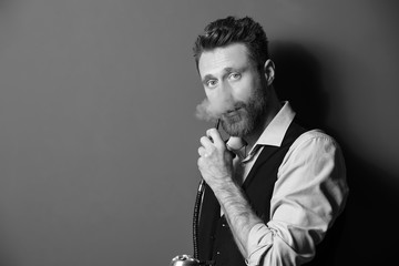 Black and white portrait of young man smoking hookah