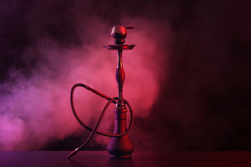 Hookah with fume on dark background