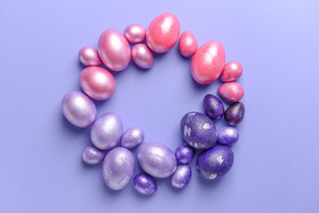Frame made of beautiful Easter eggs on color background
