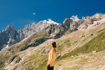 Naklejka premium tourist looking at the mountain Mont Blanc standing on the Pavillon du Mont Frety , Courmayeur Italy
