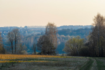 Landscape with the image of spring countryside in Tula region in Russia at sunset