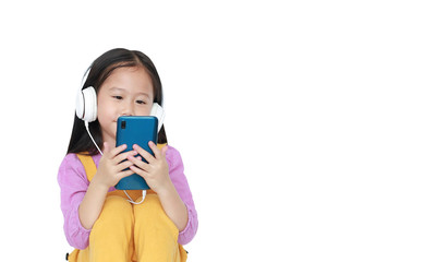 Portrait little Asian girl enjoys listening to music by headphones isolated on white background with copy space.