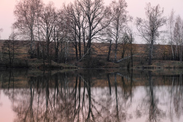 Fototapeta na wymiar Landscape with the image of spring lake at sunset
