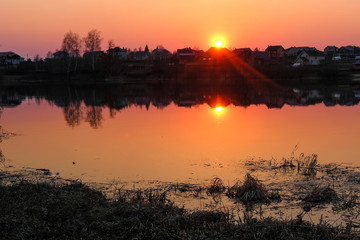 Fototapeta premium Landscape with the image of spring lake at sunset