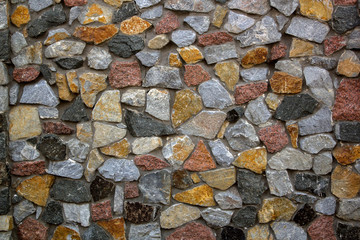 Foundation construction wall from natural colorful stones