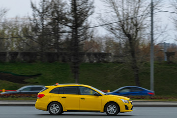 Fototapeta na wymiar Moscow, Russia - April, 27, 2019: image of yellow taxi on Moscow street in Moscow