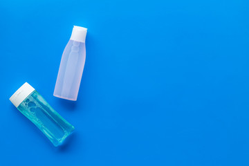 Organic cosmetics for face clearing with facial tonic and mycelial water on blue background top view copy space