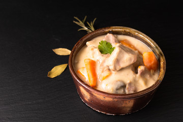 Classic French food concept Blanquette de Veau or Veal in White Wine Sauce in handmade ceramic cup with copy space
