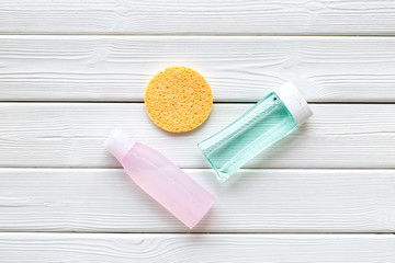 mycelial water , lotion and sponge for skin care on white wooden background flat lay space for text