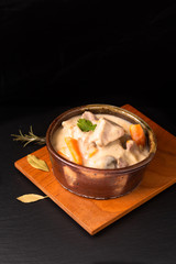 Classic French food concept Blanquette de Veau or Veal in White Wine Sauce in handmade ceramic cup with copy space