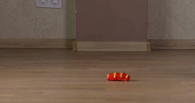Cute and funny smiling baby boy crawling on floor at living room. funny video like a baby crawling over a toy caterpillar