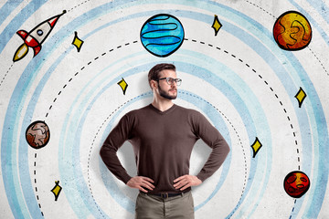 Man with glasses wearing casual clothes on cartoon solar system and space rocket background