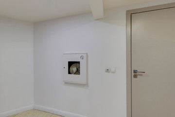 Fire hoses packed inside of white emergency box at the wall