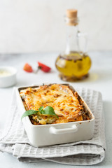 Tasty lasagne with meat, cheese on white plate
