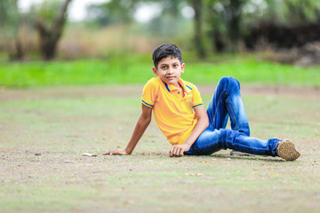 Cute Indian little boy playing in the park