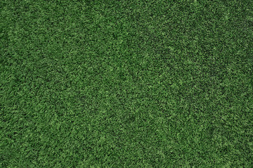 Fototapeta na wymiar Top view of artificial grass, texture of green artificial lawn.