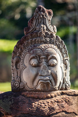 Head sculptures on the bridge leading to the south gate at Angkor Thom temple complex, Siem Reap,...